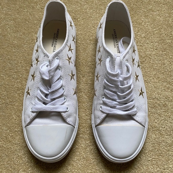 white sneakers with gold stars